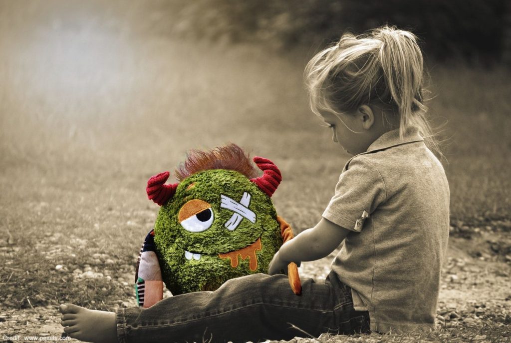 Child Playing with Doll - Dealing with the Effects of Childhood Trauma